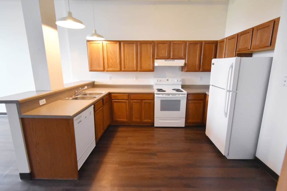 Wooden cabinets with white appliances at Straus Lofts in Saint Paul, Minnesota