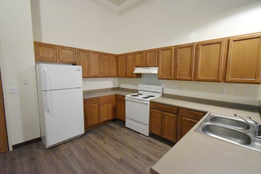 White refrigerator and stove in kitchen at Straus Lofts in Saint Paul, Minnesota