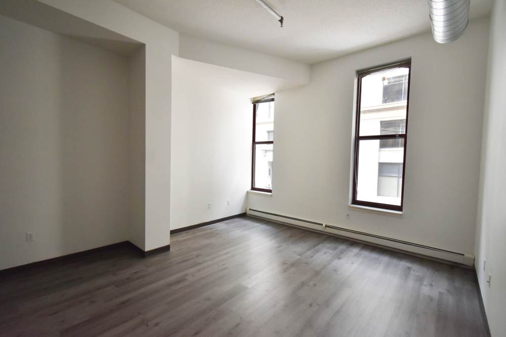 Two windows with white walls and gray flooring at Straus Lofts in Saint Paul, Minnesota
