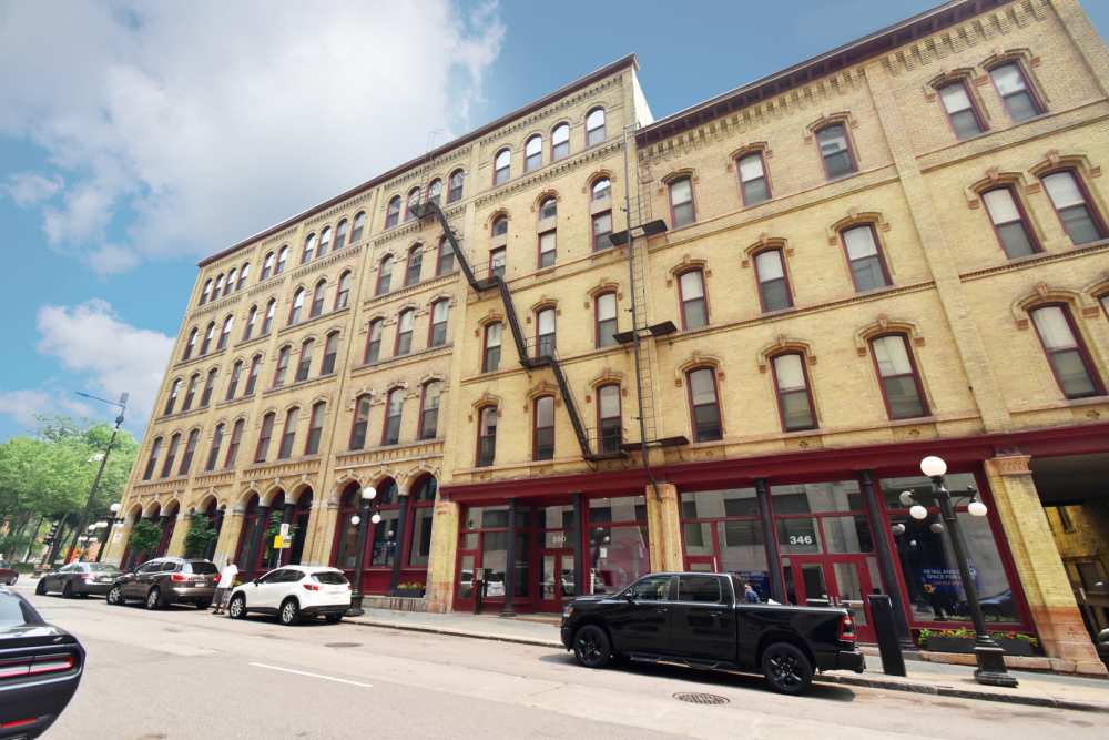 Historic brick building with multiple windows at Straus Lofts in Saint Paul, Minnesota