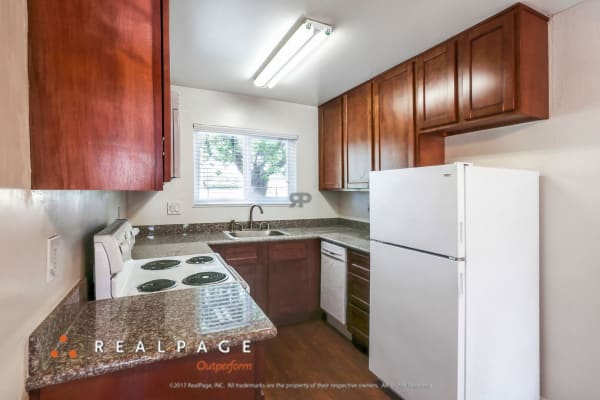 Model kitchen with granite countertops at Washington Townhomes in San Lorenzo, California