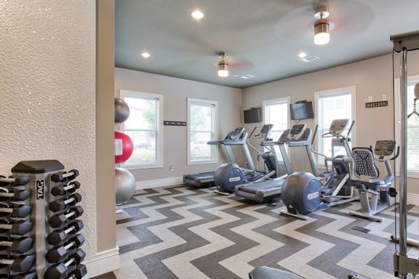 Resident working out in the on-site fitness center at Parkside Towns in Richardson, Texas