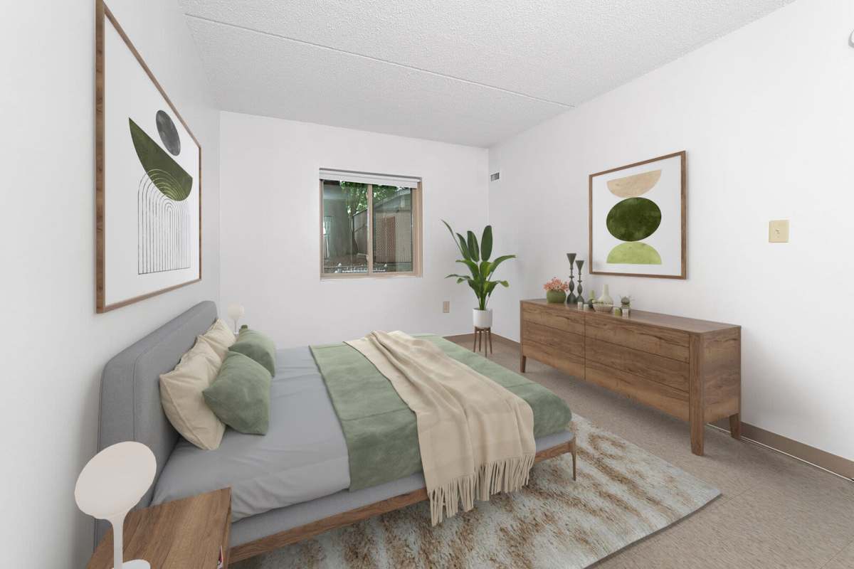 Spacious bedroom with large comfortable bed at Cardinal Medeiros Manor in Dorchester, Massachusetts,