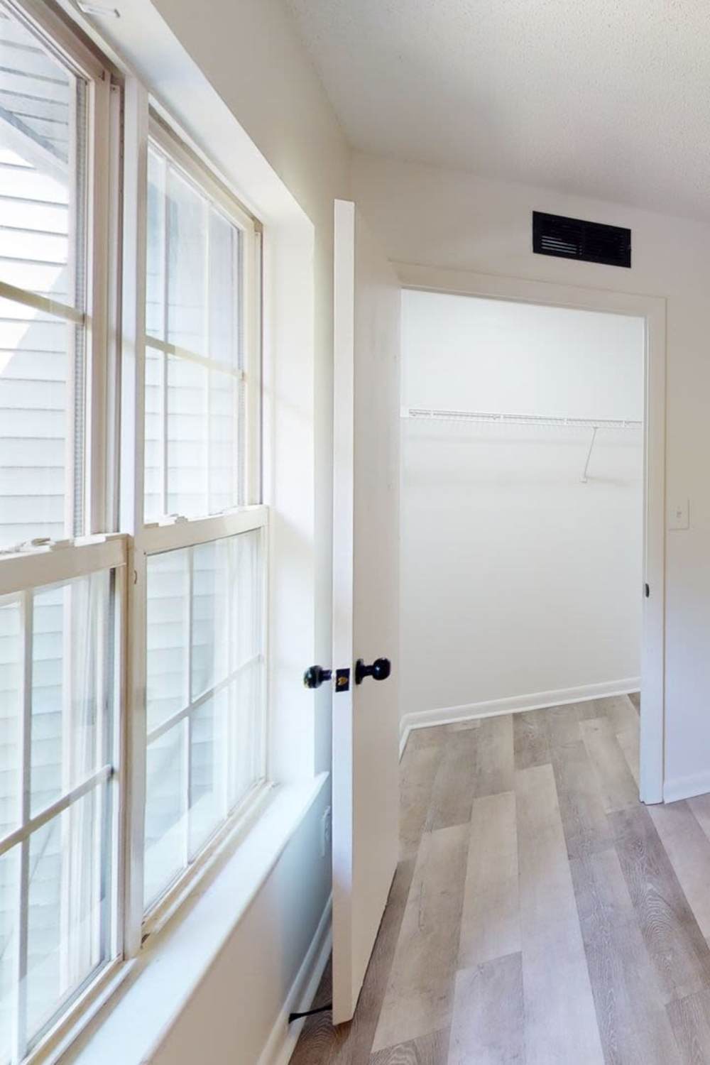 Bedroom with walk-in closet at Wallace Terrace Apartments in Charlotte, North Carolina