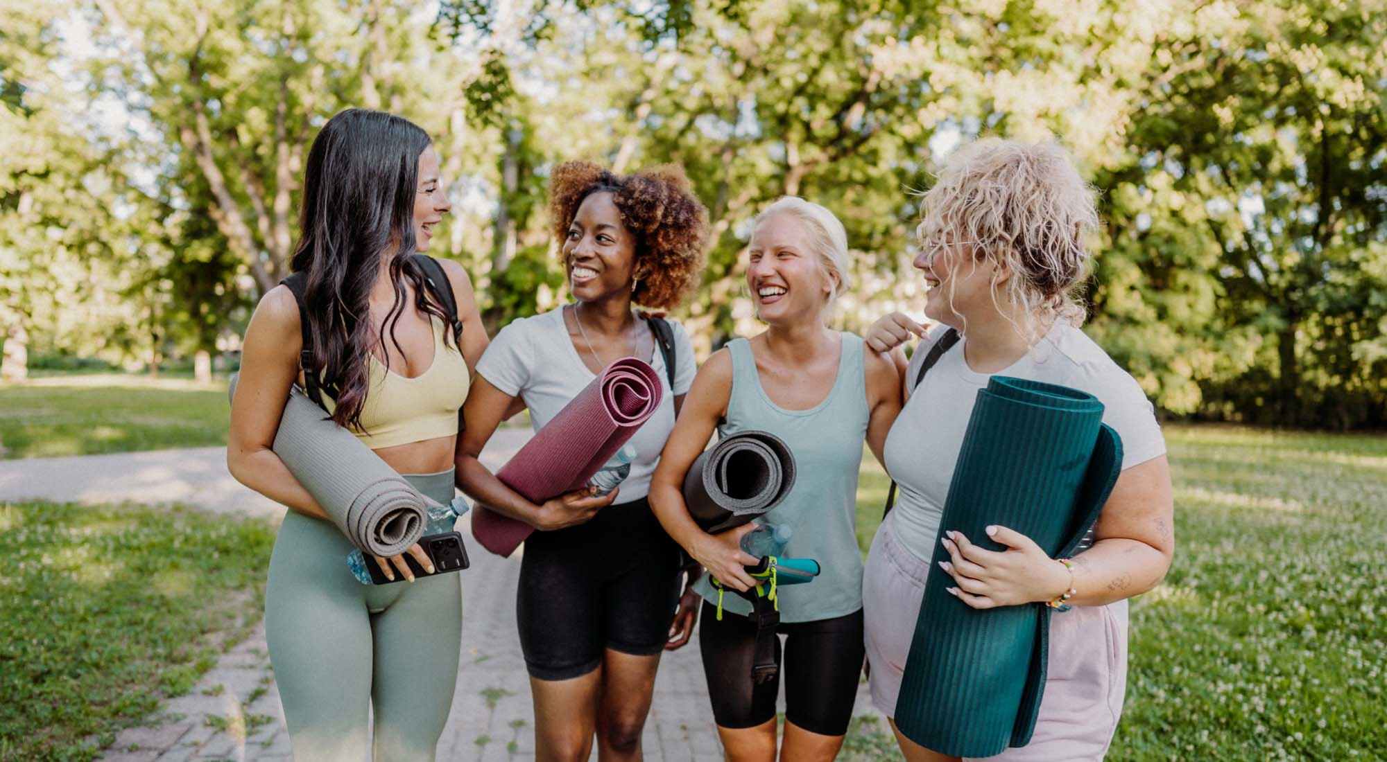 Residents with yoga mats at Neighborhood | Pine Cove Apartments in Oregon, Wisconsin
