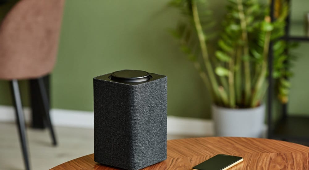 Smart phone with speaker on table in a model home's living space at Altoview Apartment Homes in Charlottesville, Virginia
