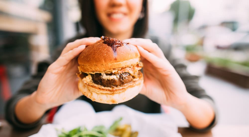 A resident enjoys a delicious burger near LaCabreah in Brownsburg, Indiana