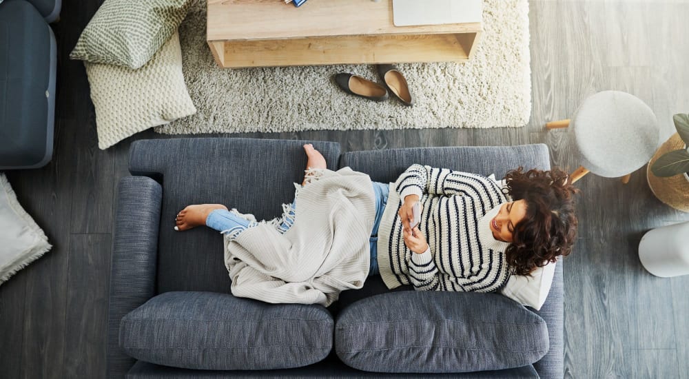 A resident relaxes in her apartment at Fox Plan Apartments in Monroeville, Pennsylvania