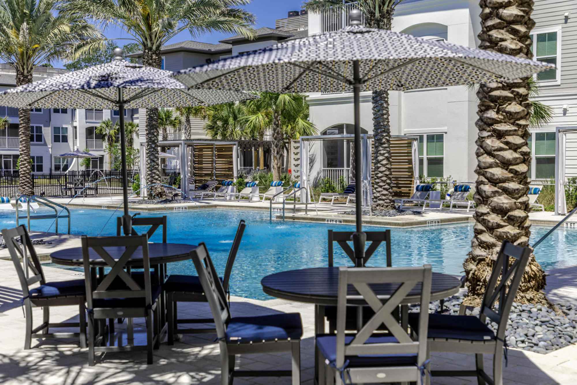 Sun-shades and seating around the pool area at The Beacon in New Smyrna Beach, Florida