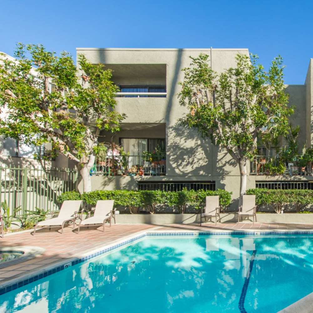 Resort-style pool with lounge chairs at Encino Crest Apartments in Encino, California