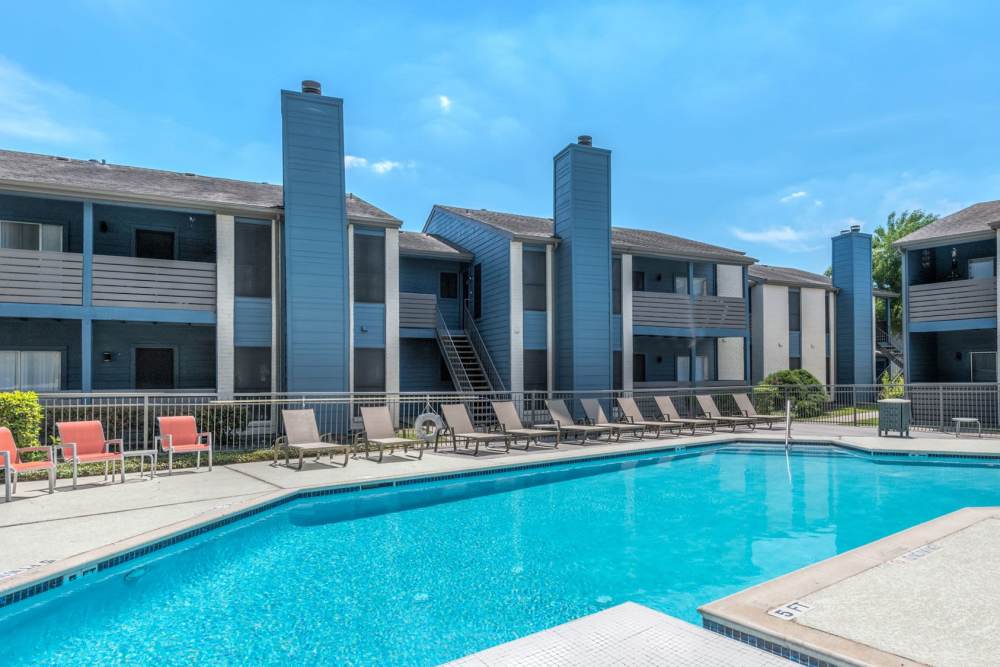 Resort-style pool with lounge chairs at Warwick at Westchase, Houston, Texas