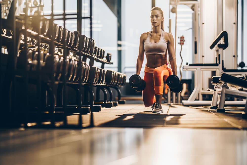 Resident staying in shape in the fitness center at The Enzo at Ariston in Buford, Georgia