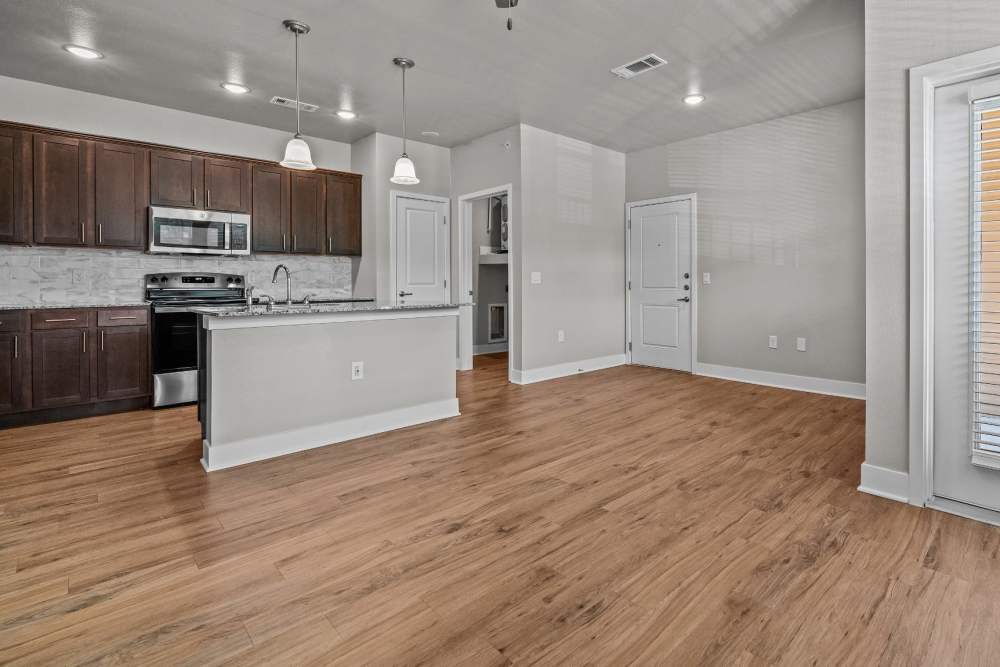 View of the kitchen from the living room at Pebble Brook Apartments in Jacksonville, Texas