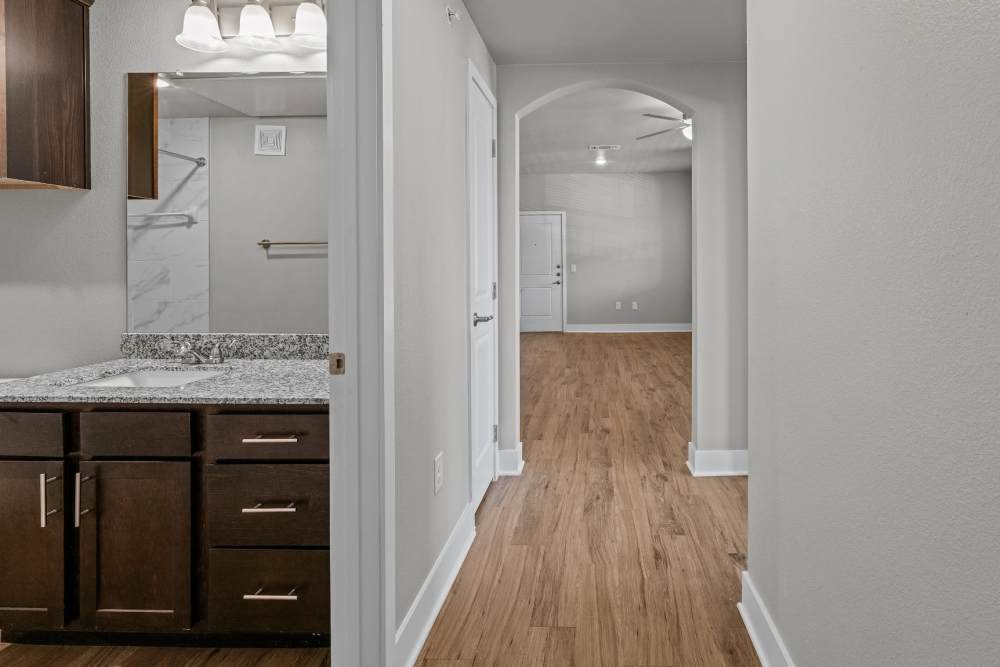 View of the kitchen from the living room at Pebble Brook Apartments in Jacksonville, Texas