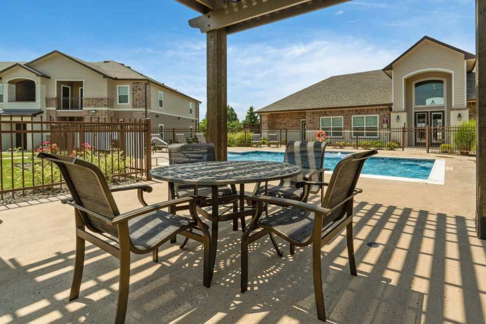 Outdoor seating area in the poolside cabana at Pine Creek in Paris, Texas