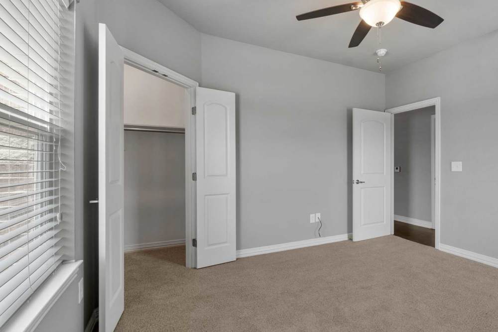 Bedroom with walk-in closets at Pine Creek in Paris, Texas