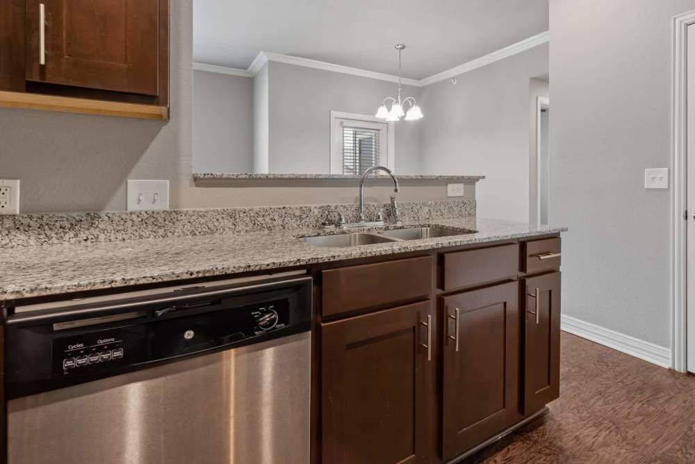 Granite countertops and stained wooden cabinetry at Pine Creek in Paris, Texas