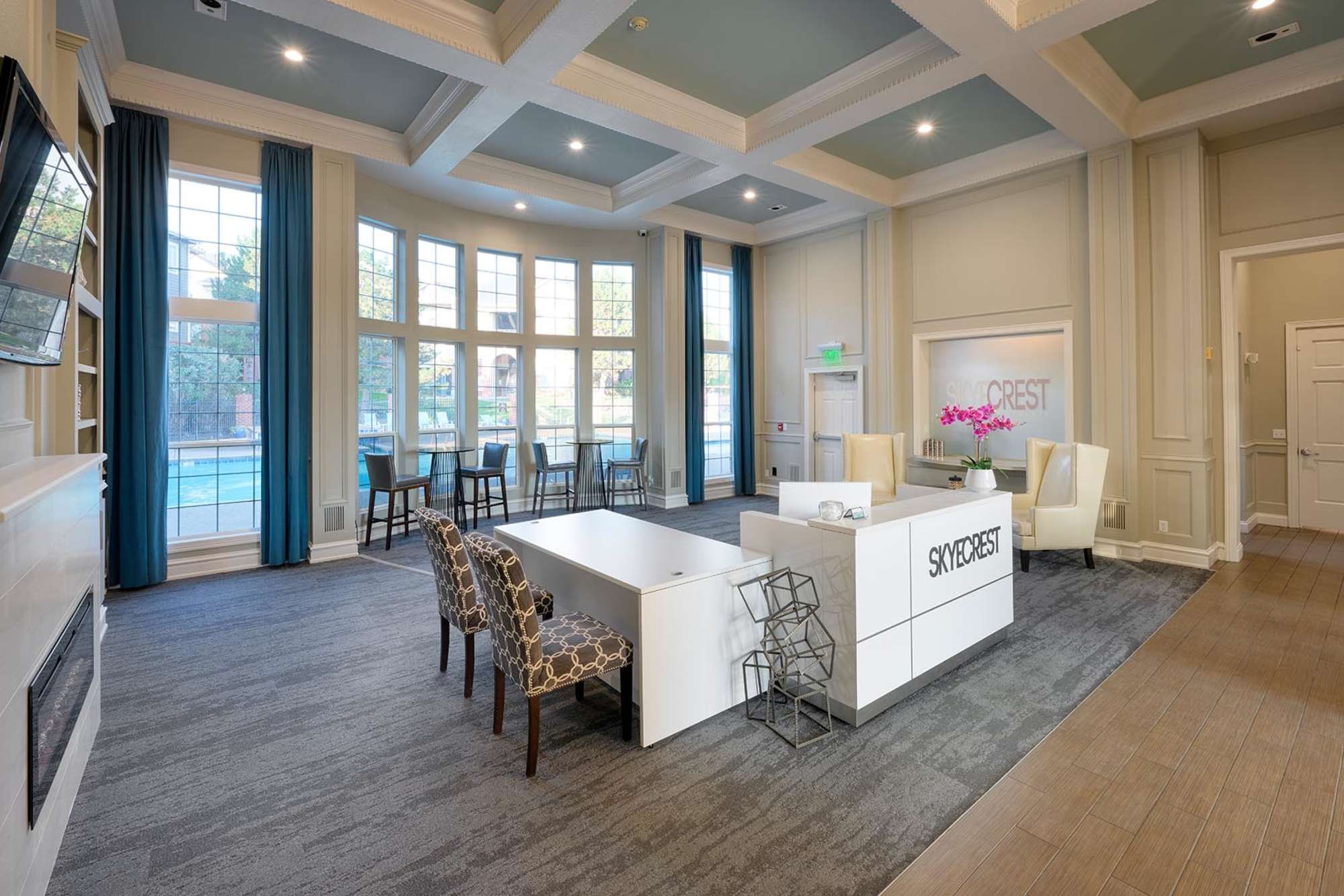 Community reception with large windows behind at Skyecrest Apartments in Lakewood, Colorado