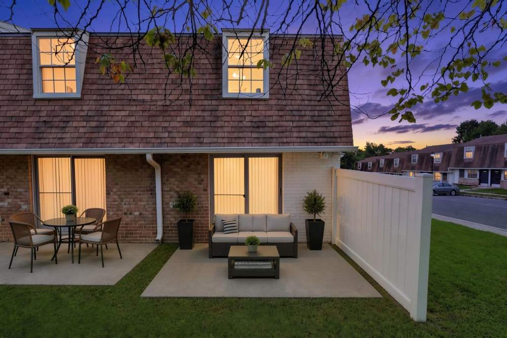Exterior building with patio furniture at Pleasant View Townhomes in Baltimore, Maryland