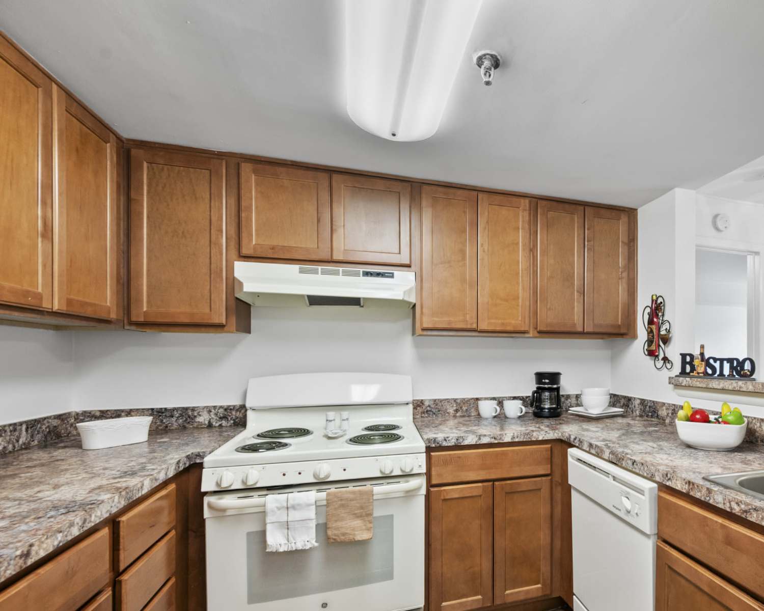 Kitchen with white appliances at Rollingcrest Commons in Hyattsville, Maryland
