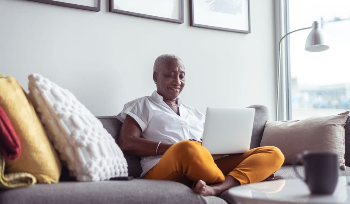 A resident browses the web with her laptop at Acclaim at Belmont Bay, Woodbridge, Virginia