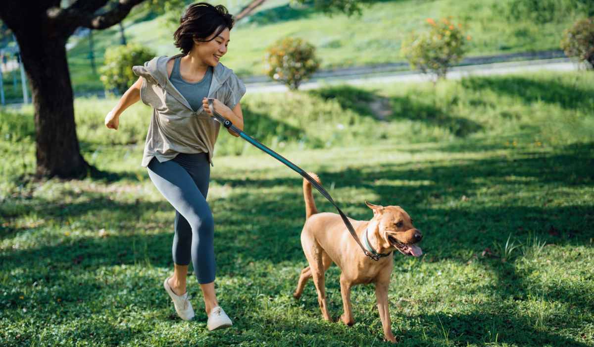 Resident walking her dog outside at Emerald Place in Lancaster, Ohio