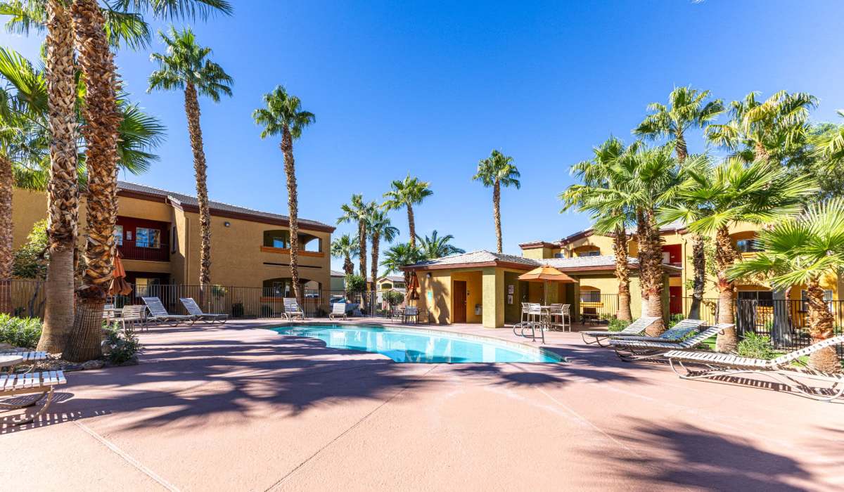 Large swimming pool with poolside lounge chairs at La Serena at the Heights in Henderson, Nevada