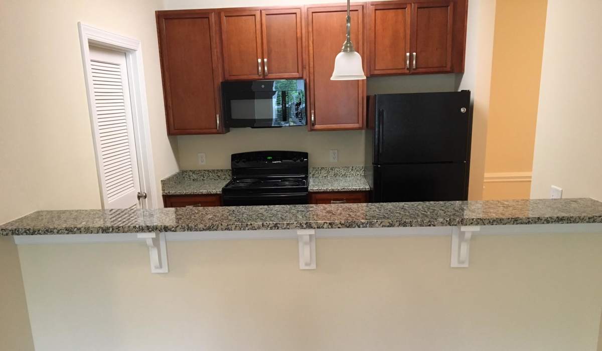Apartment kitchen with granite countertops at Palisades at Legacy Oaks in Knightdale, North Carolina