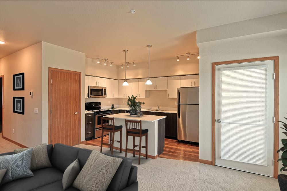 Open floor plan kitchen with island at Courtyard 465 Apartments in Wenatchee, Washington