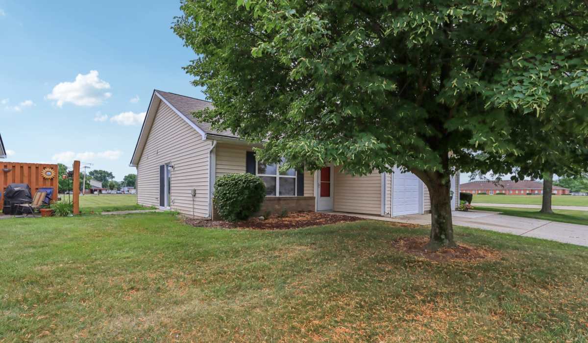 Property exterior with tree at Broadway Village Apartments in Greenfield,Indiana