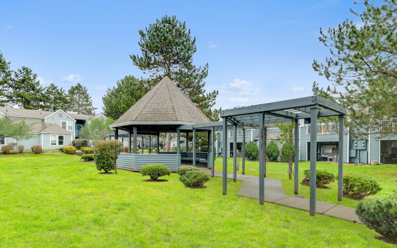 Lush landscaping around a gazebo at Meadows at Cascade Park Apartments in Vancouver, Washington