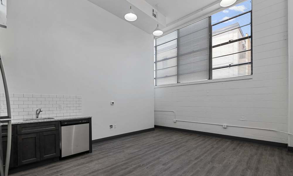 Unfurnished living area with connecting kitchen at The Lofts at the Municipal in Lafayette, Louisiana