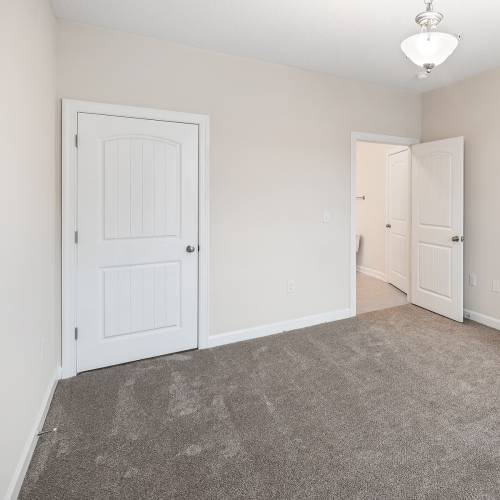 Unfurnished bedroom with access to another room at Brittany Place Hendersonville in Henderson, North Carolina