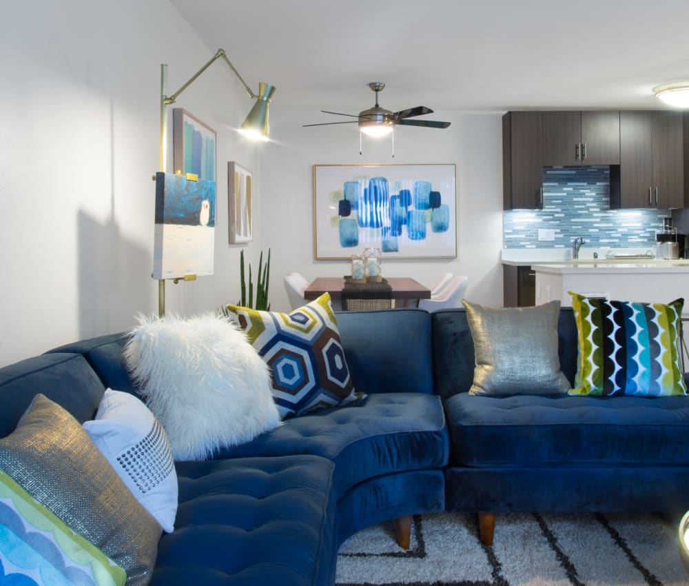 View of the modern kitchen with a custom tile backsplash from the living area of a model home at Sofi Belmont Glen in Belmont, California