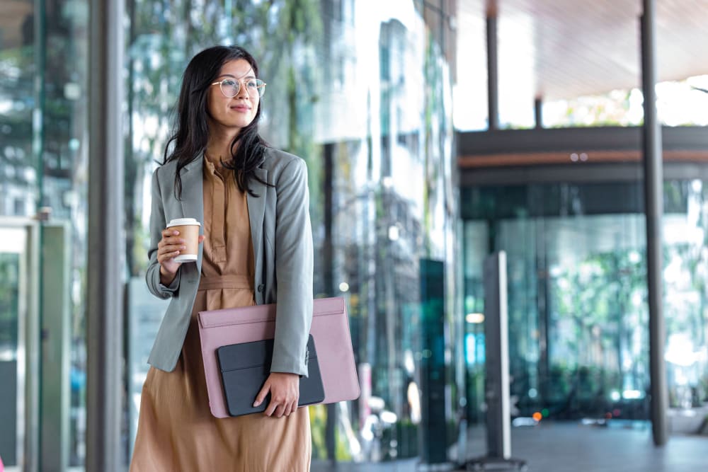 Resident walking to class with her coffee in hand near Thirteen15 in New Orleans, Louisiana