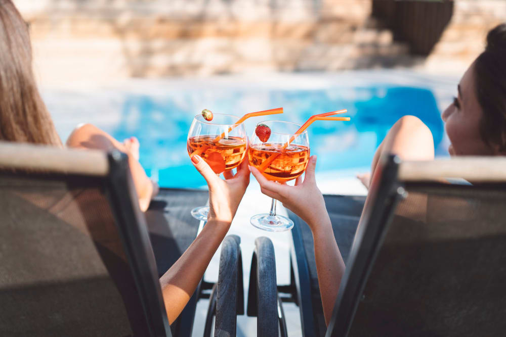 Residents having drinks by the pool at Alexan Park West in Peoria, Arizona