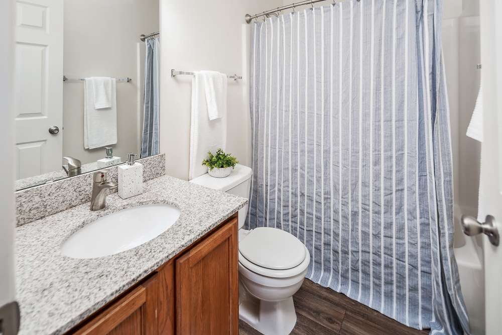 Bathroom with mirror and storage space at Huntersville Commons in Huntersville, North Carolina