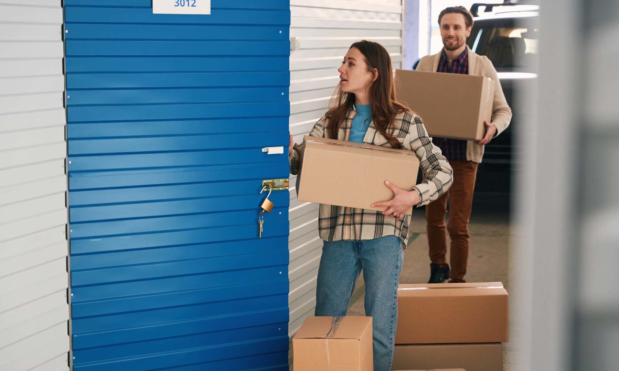 Couple carrying the storage boxes at Self Storage and RV at Verrado in Buckeye, Arizona