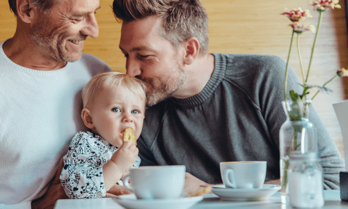 A happy resident couple with their toddler at Vestara 72 in Papillion, Nebraska