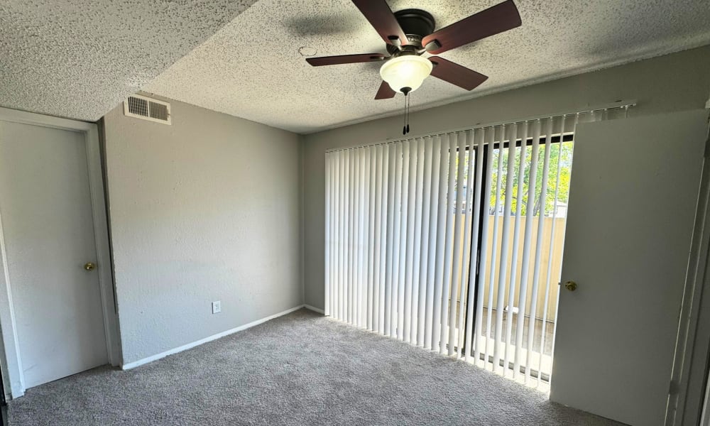 Bedroom with a barn door at Santa Fe Apartments in Dallas, Texas