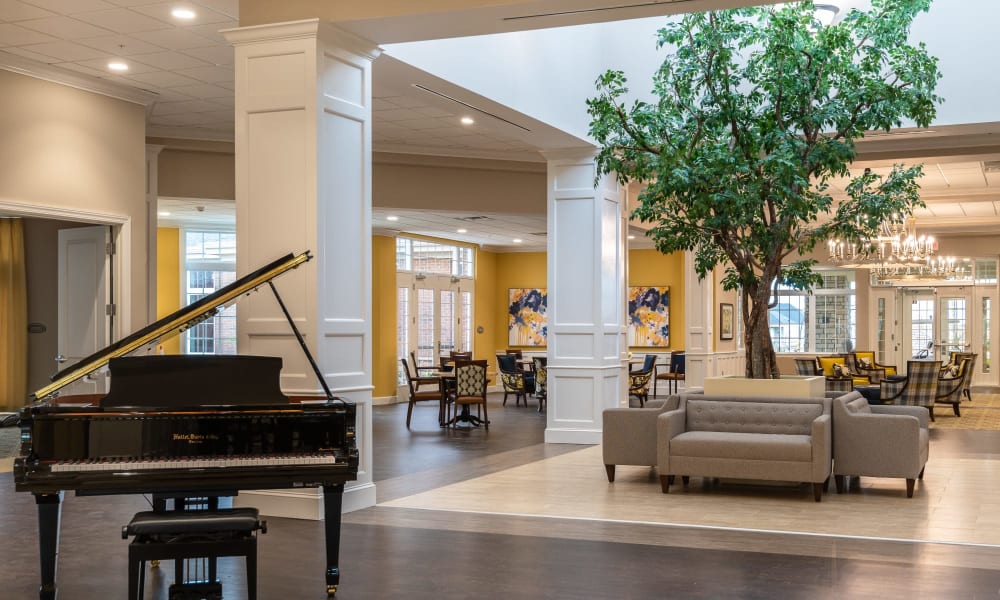 Main common area with a skylight and a piano at Randall Residence of Centerville in Centerville, Ohio