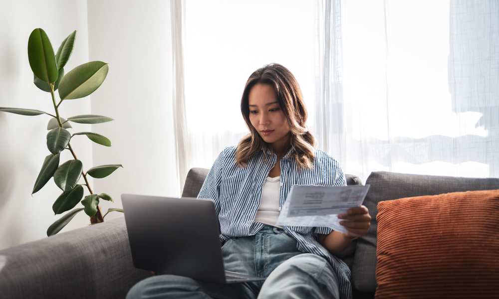 Happy resident checking out our online resources from her new apartment at Charthouse at James Island in Charleston, South Carolina