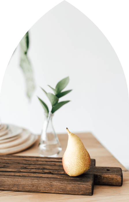 A pear and a plant on the table at One Park in West Hartford, Connecticut