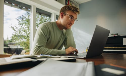 Resident on his laptop at 24Hundred Apartments in Oklahoma City, Oklahoma