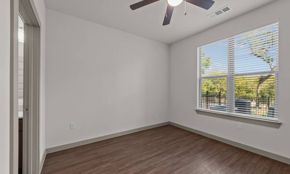 Bedroom with large windows at Opal Point at Kyle in Kyle,Texas