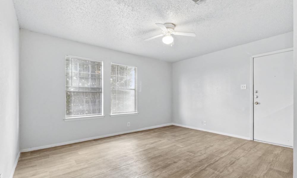 Well-lit apartment bedroom with ceiling fan at Arbors of Taylor in Taylor, Texas