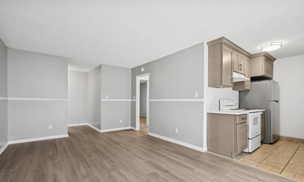 Unfurnished living room with view to kitchen at Newland Garden Apartments in Garden Grove, California