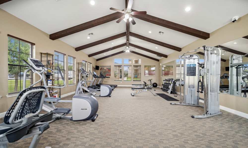 Fitness center with large windows at Vistas at Red Creek in San Angelo, Texas