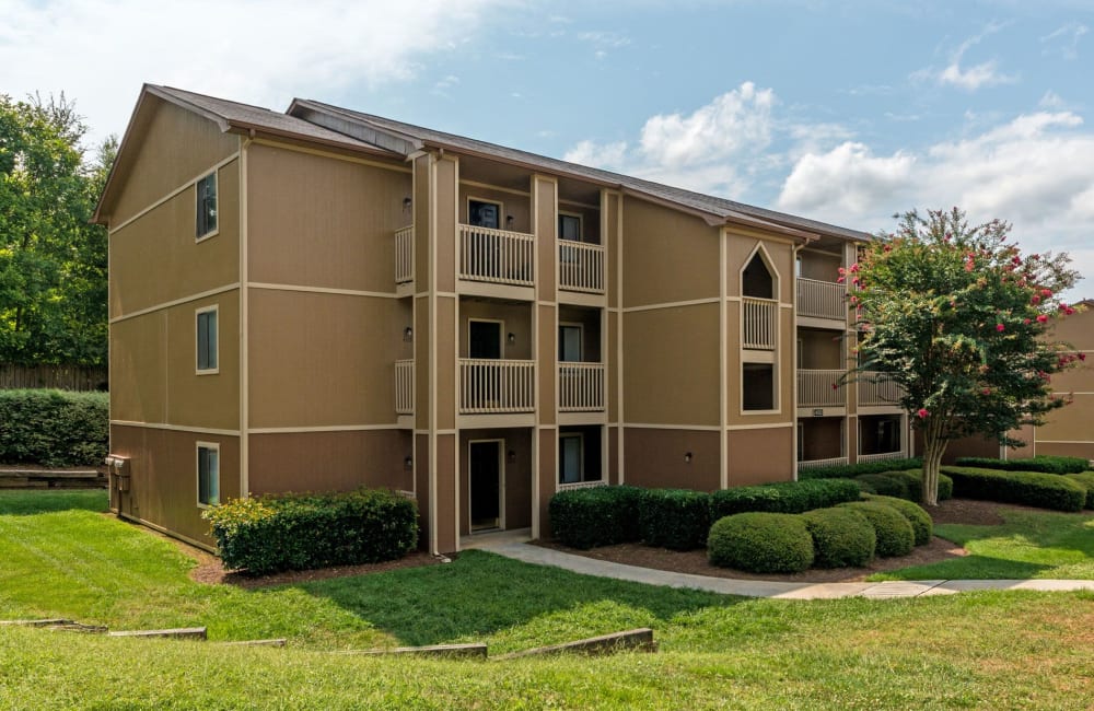 Exterior with private patio and lush lawn at Waters Edge Apartment Homes in Concord, North Carolina