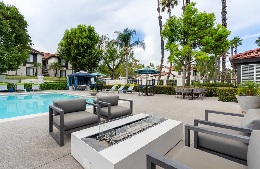 Poolside lounge chairs and fire pit at Brookwood Villas in Corona, California